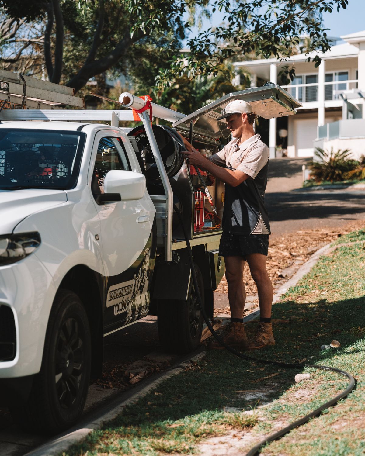 Mason loading gear into the work ute