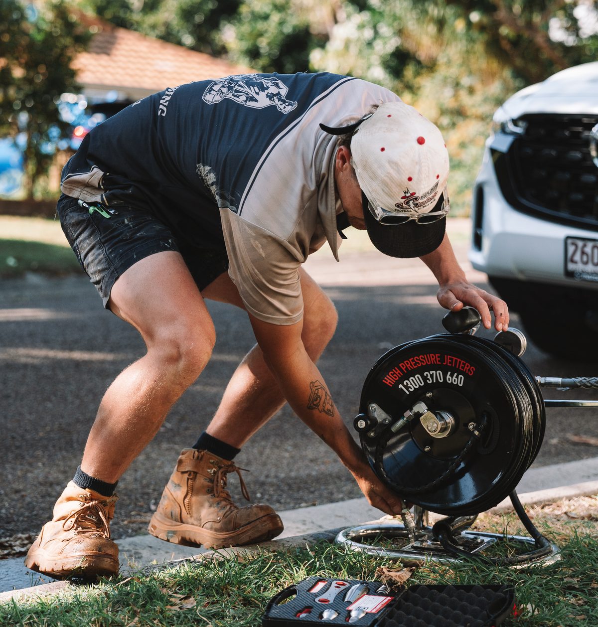 Mason from Sunshine Coast Relining setting up the drain jetter reel on the kerb